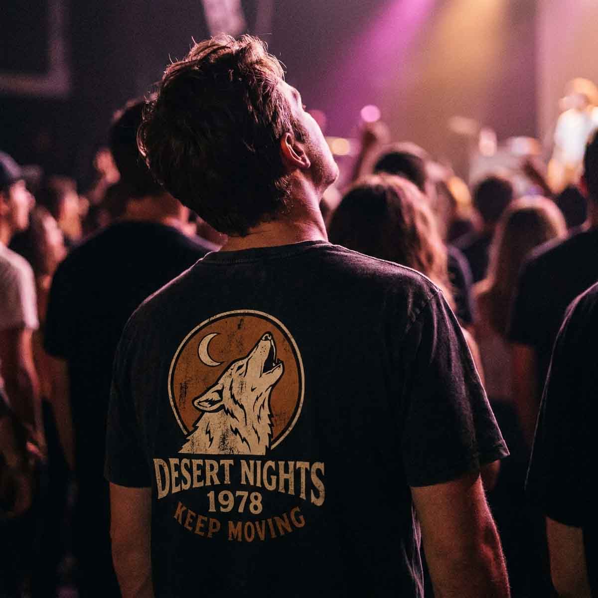 Back of someone's head at a live gig, distressed wolf badge tee